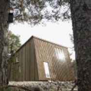 This modern resort cabin in Sweden has a design inspired by camping tents. It has two bedrooms and a loft in 969 sq ft. | www.facebook.com/SmallHouseBliss
