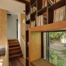 This vertically-oriented house with 1 bedroom and a small loft in 872 sq ft uses a split-level design to step down its steep site. | www.facebook.com/SmallHouseBliss