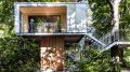 A pair of modern treehouses at the edge of a forest provide leafy retreats complete with kitchenette and bath. | www.facebook.com/SmallHouseBliss