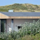This vacation cottage sits on the sand dunes of a Dutch coastal island. It has two small bedrooms in 646 sq ft. | www.facebook.com/SmallHouseBliss