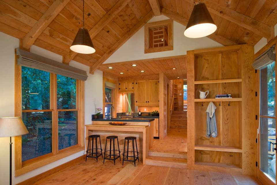 This rustic guest cabin features extensive custom interior woodwork. It has one bedroom and a sleeping loft in 714 sq ft. | www.facebook.com/SmallHouseBliss
