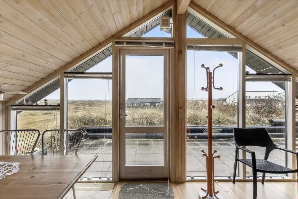 This tiny sod-roofed house sits among the sand dunes in northern Denmark. It has one bedroom in 430 sq ft. | www.facebook.com/SmallHouseBliss