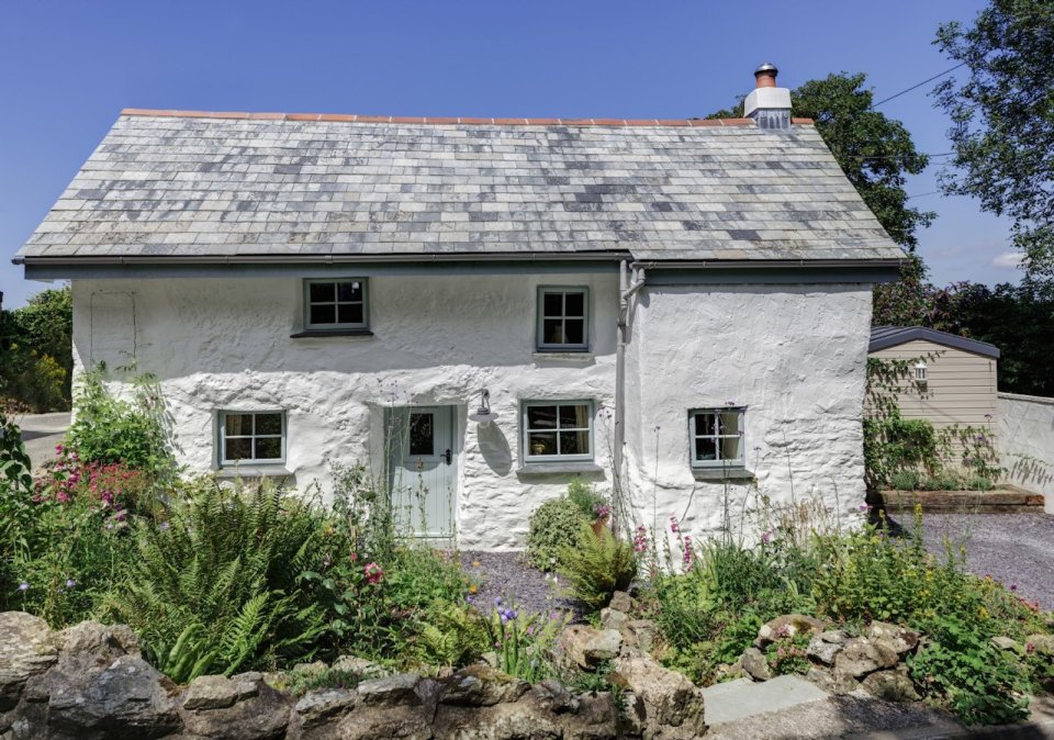 Sweetpea Cottage, a 300-year-old plastered stone cottage in Cornwall. The two-bedroom cottage was built in 1680 and recently updated in a "vintage country glamour" style to brighten the interior. | www.facebook.com/SmallHouseBliss