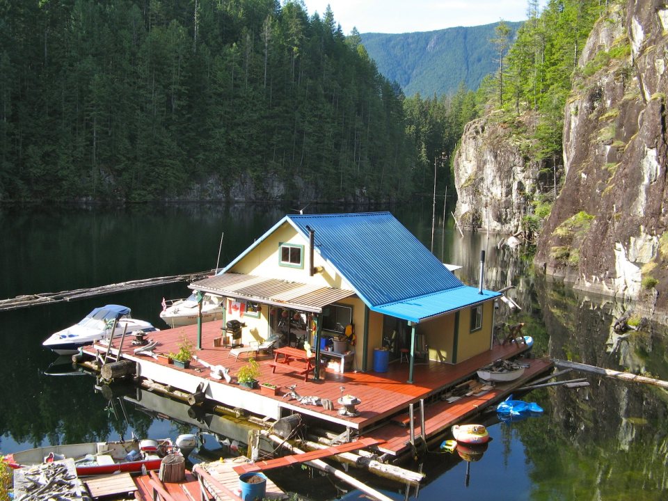 An off-grid floating cabin on Powell Lake, British Columbia. Built on a raft of cedar logs, the 675 sq ft cabin has 2 small bedrooms and a loft. | www.facebook.com/SmallHouseBliss