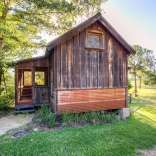 The rustic Cowboy Cabin was built from salvaged materials. The 12'x28' cabin has 2 sleeping lofts. | www.facebook.com/SmallHouseBliss