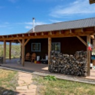 This small straw bale house is off the grid on 40 acres of Colorado pasture, forest and canyon. It has one bedroom on the 468 sq ft ground floor plus a loft. | www.facebook.com/SmallHouseBliss
